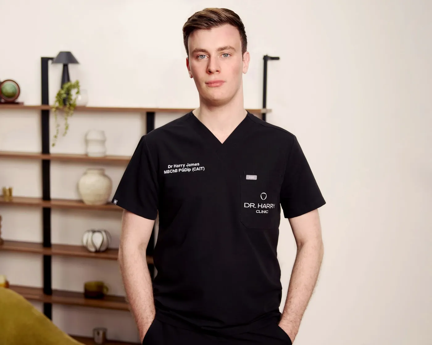 Dr Harry James standing in the consultation room at Dr Harry Clinic